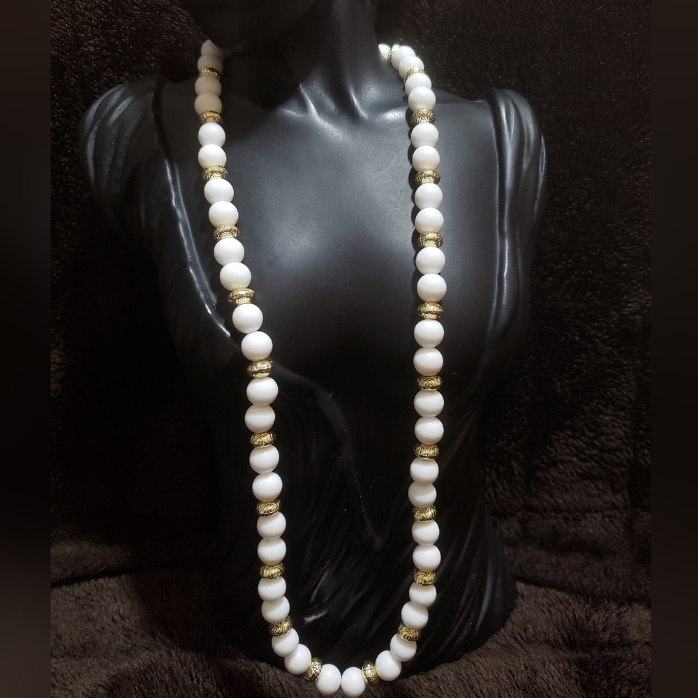 Antique necklace with round white and gold donut shaped beads